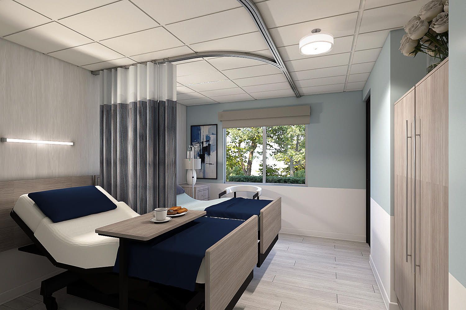 Modern hospital room with two beds, a window with a scenic view, and light blue walls.