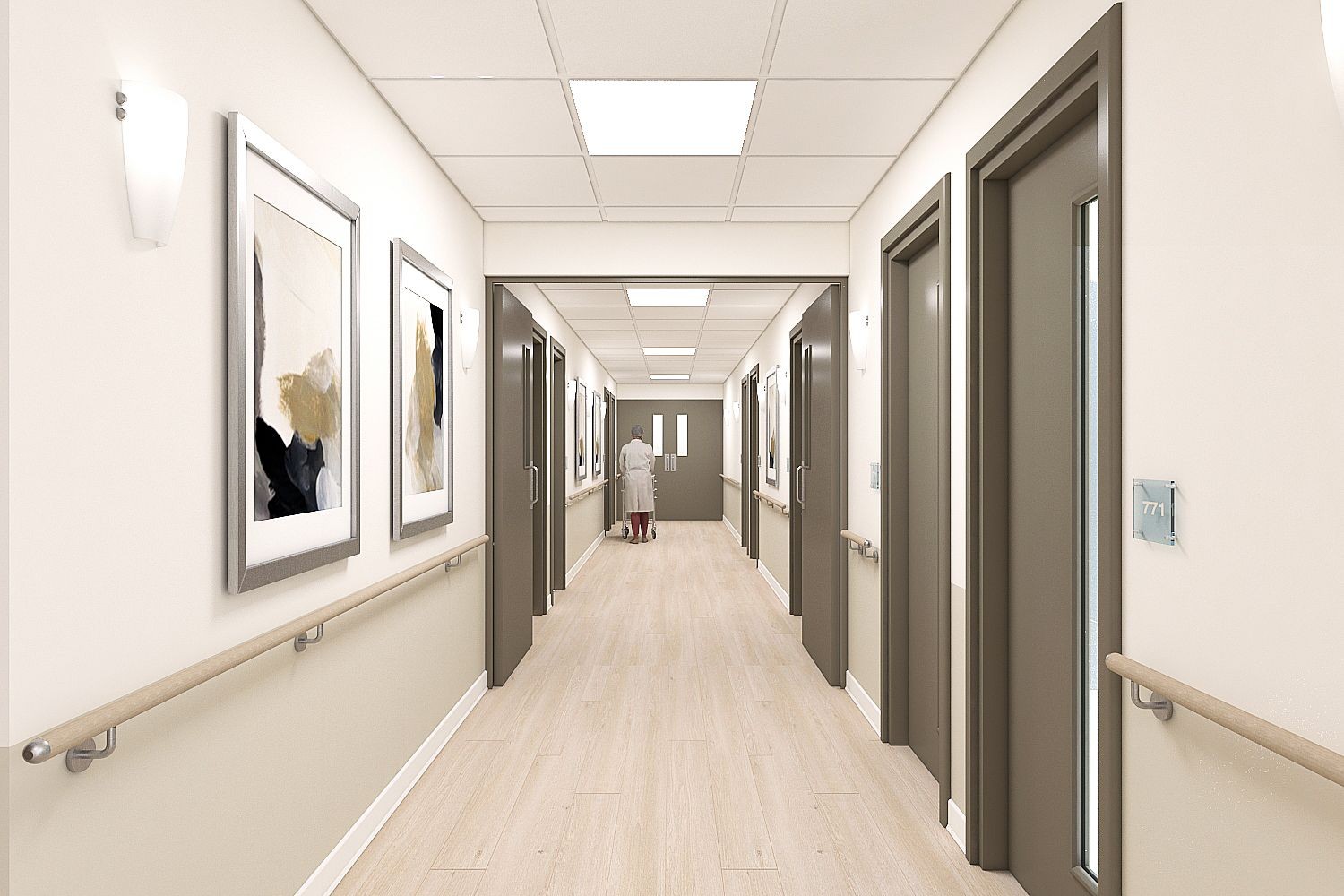 Clean, well-lit hospital corridor with framed artwork on walls and a person walking at the end.